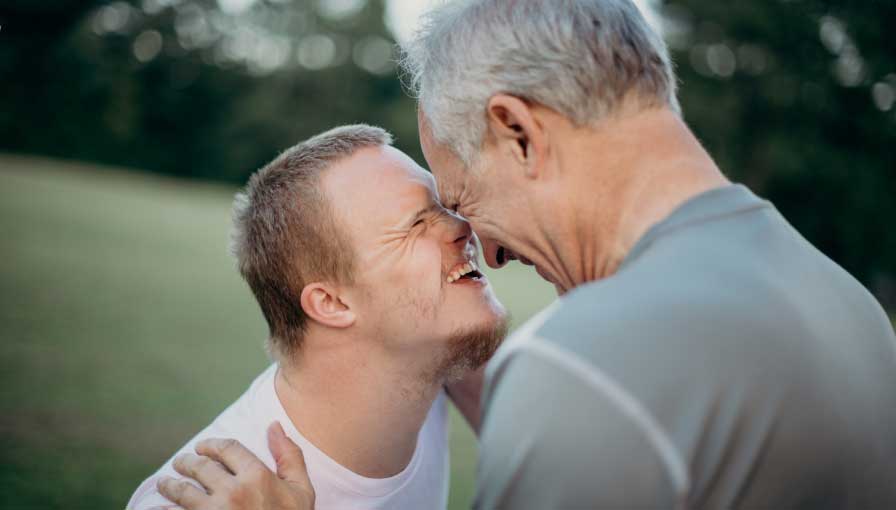 Two men gazing into each others eyes smiling